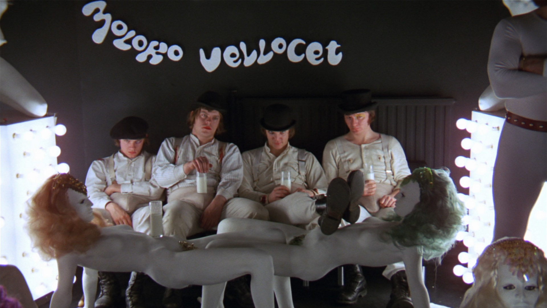 The meme is a screenshot from the 1972 film "A Clockwork Orange" where a group of young men, known as the "Droogs," are sitting in a room with a woman, and one of them is about to rape her. The text "I want to hurt you" appears in the image, but it's not a quote from the scene. The meme is likely referencing the violent and disturbing nature of the scene, and the text is being used in a humorous or ironic way to express a desire to harm someone.